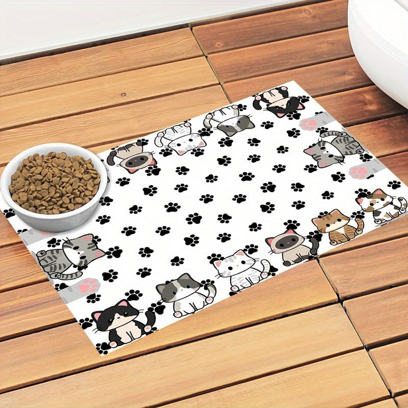 Cartoon cat and paw print mat with a white food bowl on wooden decking
