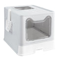 Grey enclosed cat litter box with a clear cat-ear-shaped front door and a scoop hanging on the side