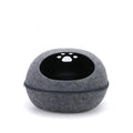 Grey felt egg-shaped cat pod with a zip around the middle and paw-print holes on top