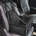 Black hanging dog booster seat strapped to a car front seat