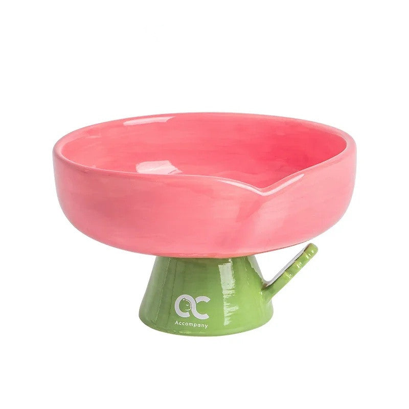 Pink ceramic flower cat bowl with a level rim on a green stem pedestal