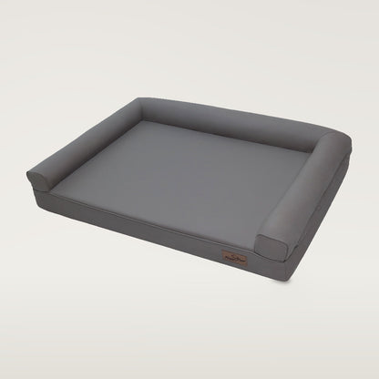 Grey faux-leather dog bed with bolsters on three sides and a small brown BingoPaw label