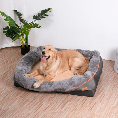 A golden retriever lying in the grey bolster bed on a wooden floor