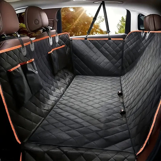 Black quilted dog seat cover with orange piping fitted across a car back seat, hanging from the headrests