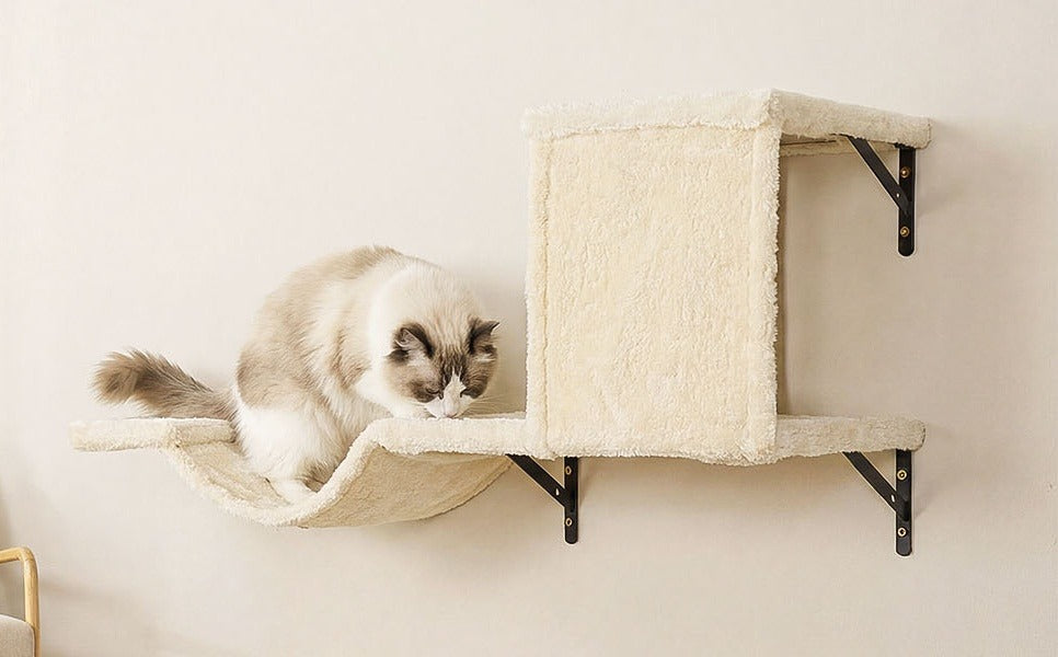 Covered beige plush cave on a shelf with a curved bridge; a ragdoll cat sits on the bridge