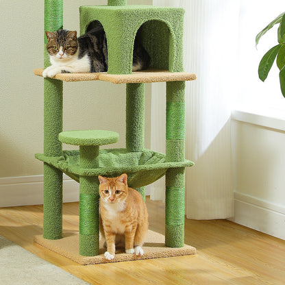 Two cats on the condo platform and the base of the green cat tree in a living room