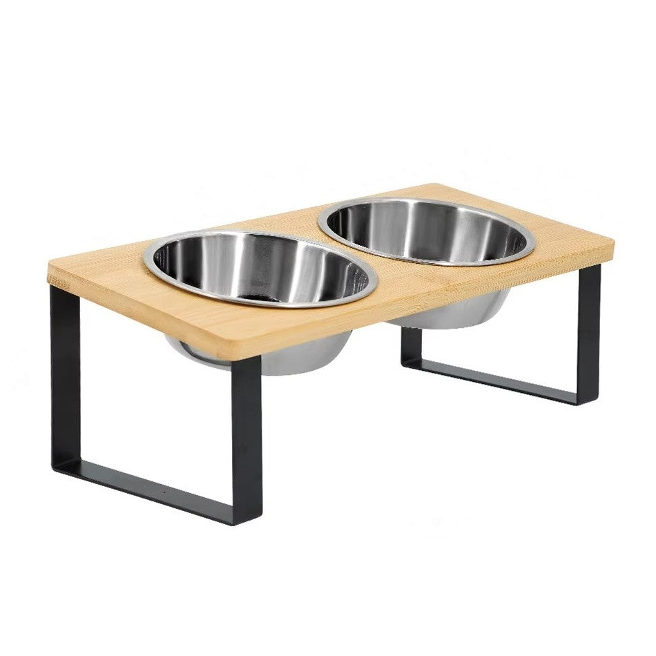 Raised bamboo feeding stand on black metal legs holding two stainless steel bowls
