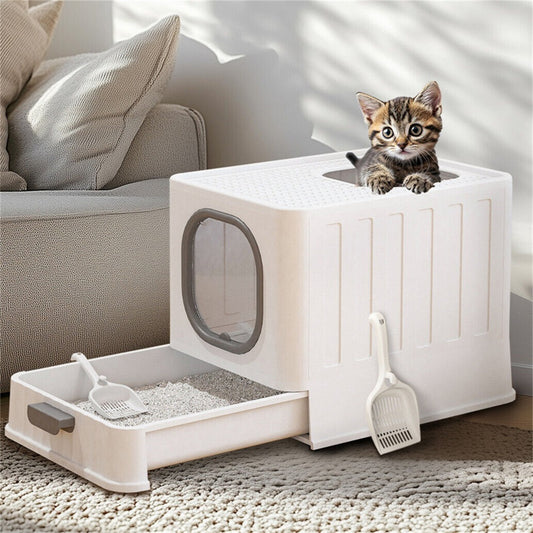 White enclosed litter box with the drawer pulled out and a kitten looking out of the top opening