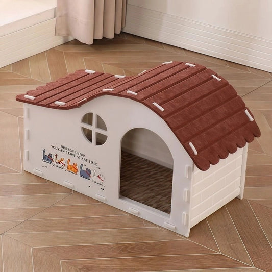 White felt cat house with a red-brown scalloped roof, round window and arched doorway on a wooden floor