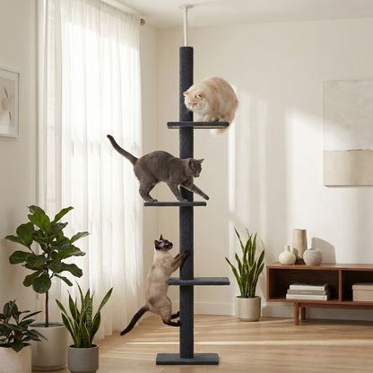 Dark grey floor-to-ceiling cat tree in a bright living room with three cats on its platforms