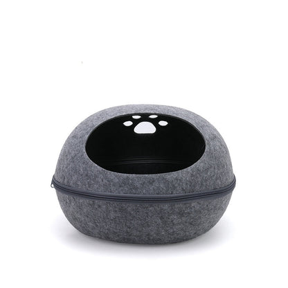 Grey felt egg-shaped cat pod with a zip around the middle and paw-print holes on top