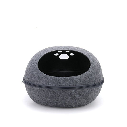 Grey felt egg-shaped cat pod with a zip around the middle and paw-print holes on top