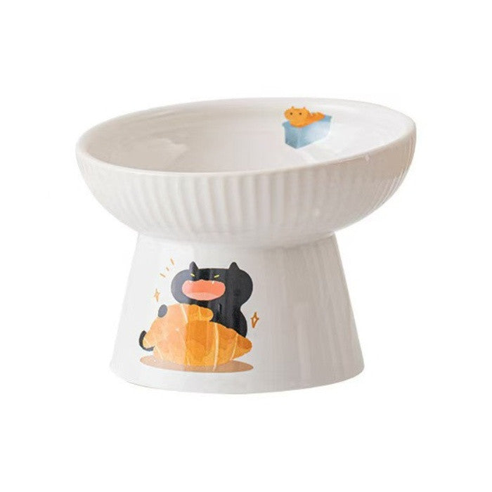 White raised ceramic cat bowl with a ribbed rim and a black cat hugging a loaf of bread printed on the base