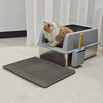 Grey high-sided litter box with a stainless steel pan, a cat inside, the scoop in its side holder and a grey mat in front