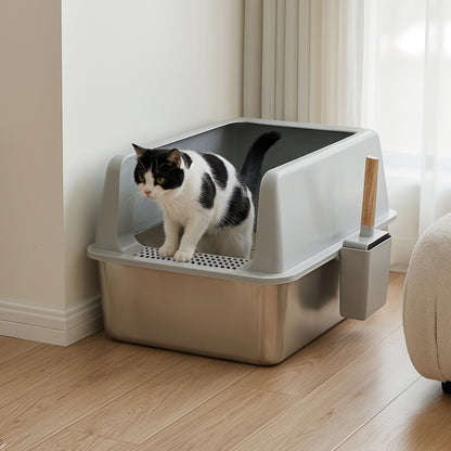Black and white cat in the stainless steel litter box with grey high sides and the scoop holder on the side